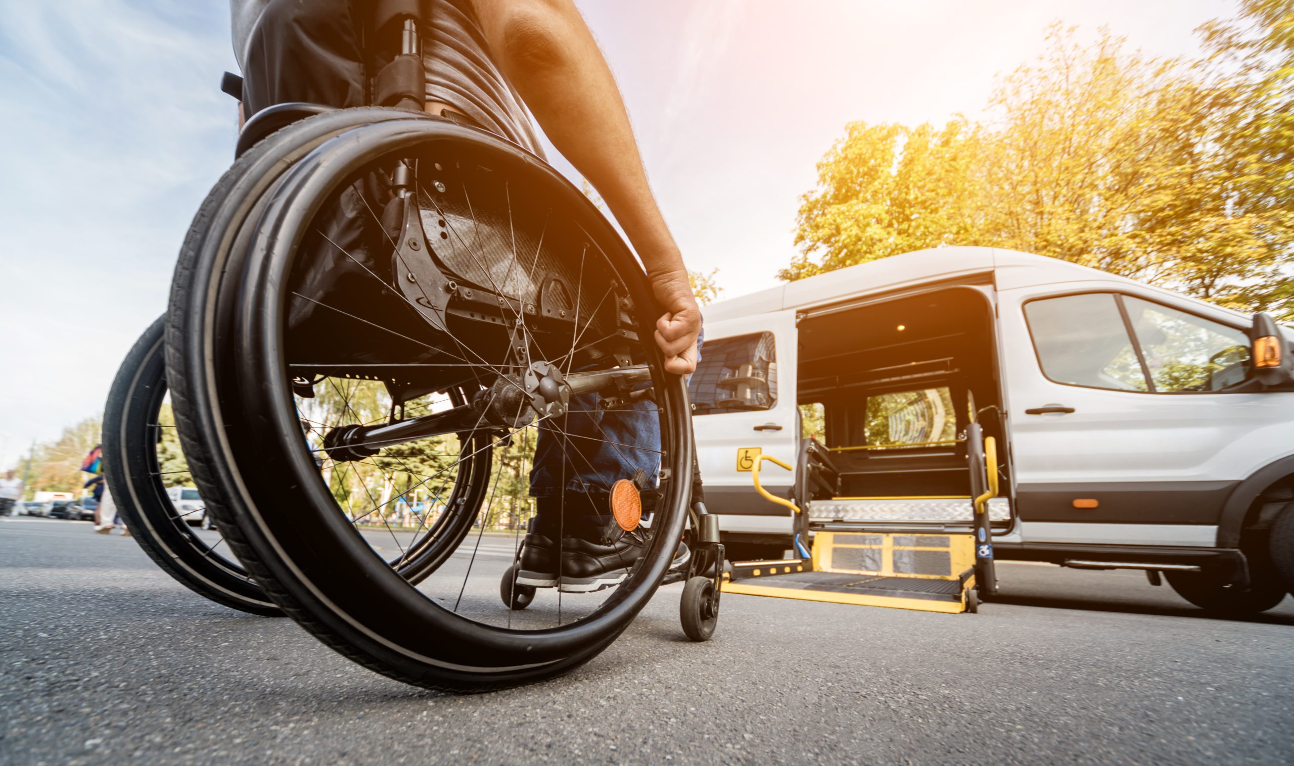 A man in a wheelchair moves to the lift of a specialized vehicle for people with disabilities A man in a wheelchair moves to the lift of a specialized vehicle for people with disabilities.